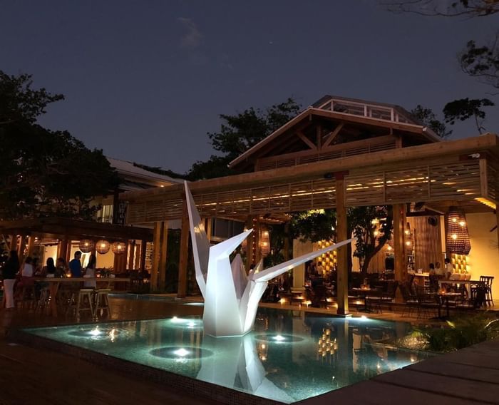 An origami statue in a pool at Ibagari Boutique Hotel