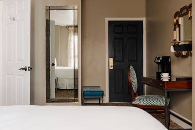 Workspace with a coffee maker and wall mirror in Deluxe Queen Room at Hotel Bijou, featuring San Francisco accommodation