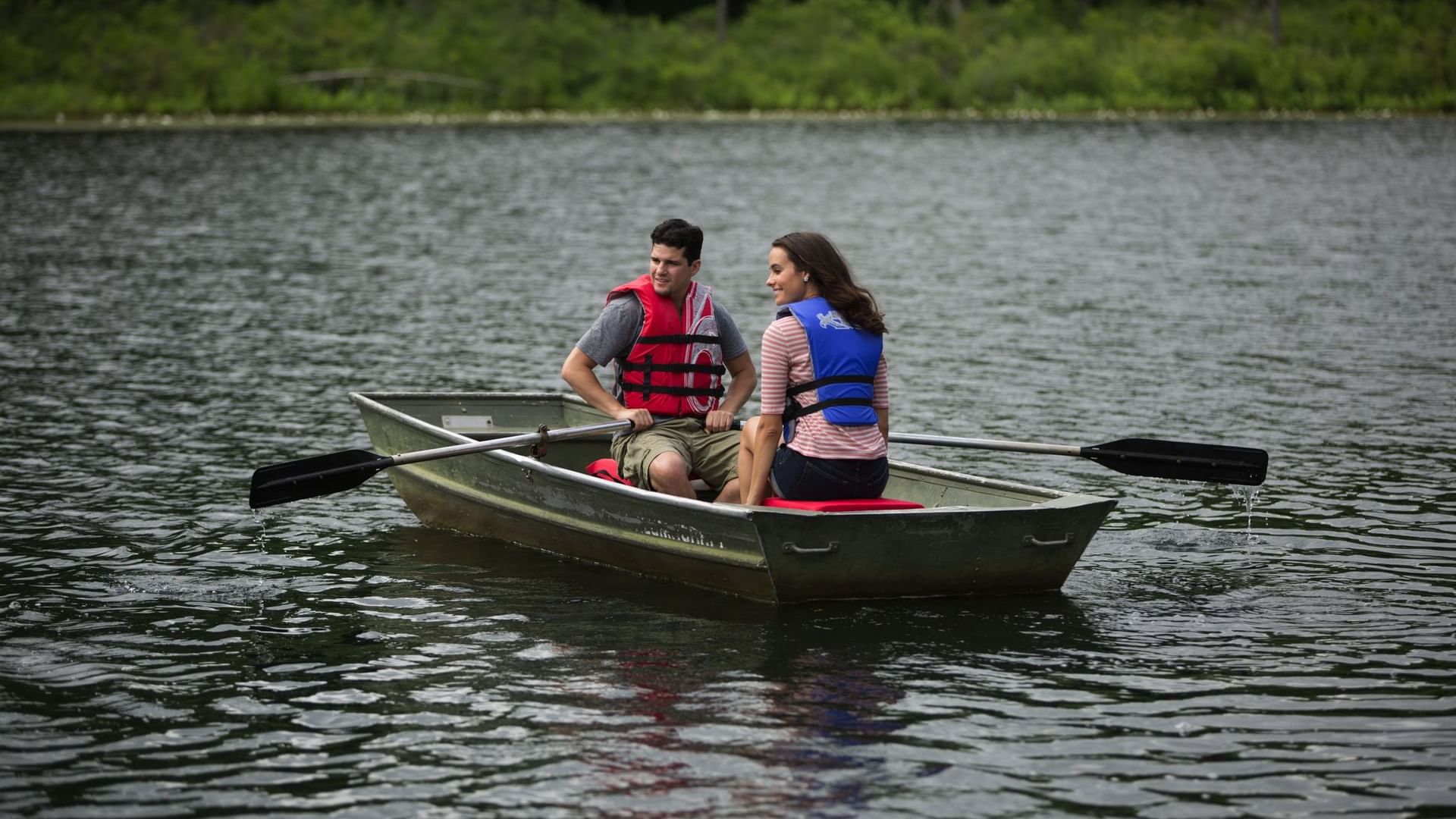 Couple observing the surrounding while enjoying a relaxing rowboat experience near Cove Pocono Resorts