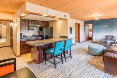 Fully equipped kitchen with breakfast bar, and stylish furniture in a suite at The Boulevard Inn & Bistro