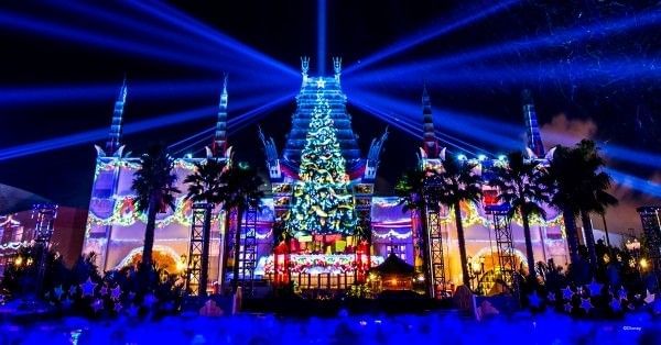 Bright lights and colors surround Christmas tree projections during Jollywood Nights at Hollywood Studios. 