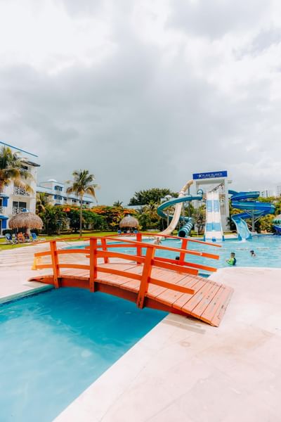 Slides by the outdoor pool area with a small bridge at Playa Blanca Beach Resort