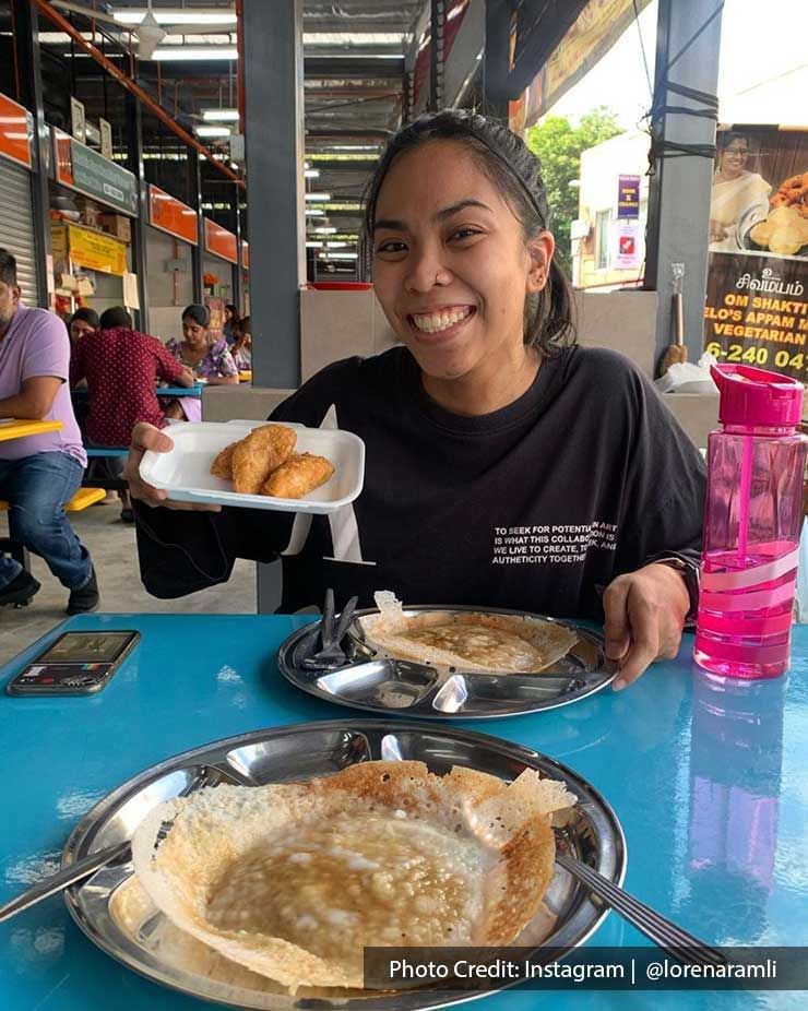 Lady posing with dishes served on a street food stall near Imperial Lexis Kuala Lumpur, Malaysian street food tour