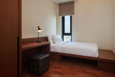 Bed & table lamp in Duo 3 Suite at Tribeca Serviced Suites