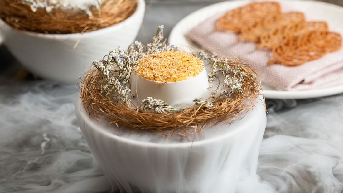 Elegant dessert in an eggshell nest with dry ice smoke served at Sunway Resort