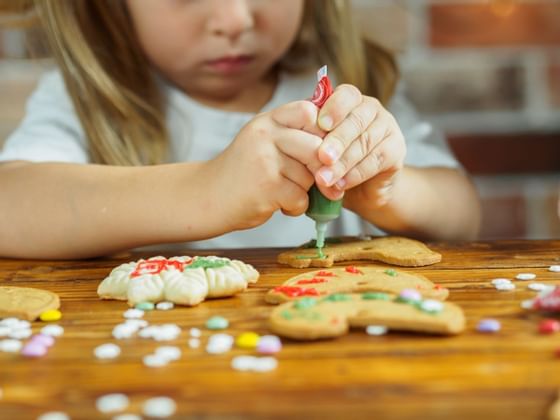 Little girl decorating cookies at Cradle Mountain Hotel