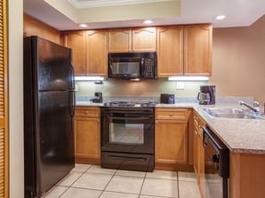 Kitchen area in 1 & 2 Bedroom Deluxe at Legacy Vacation Resorts