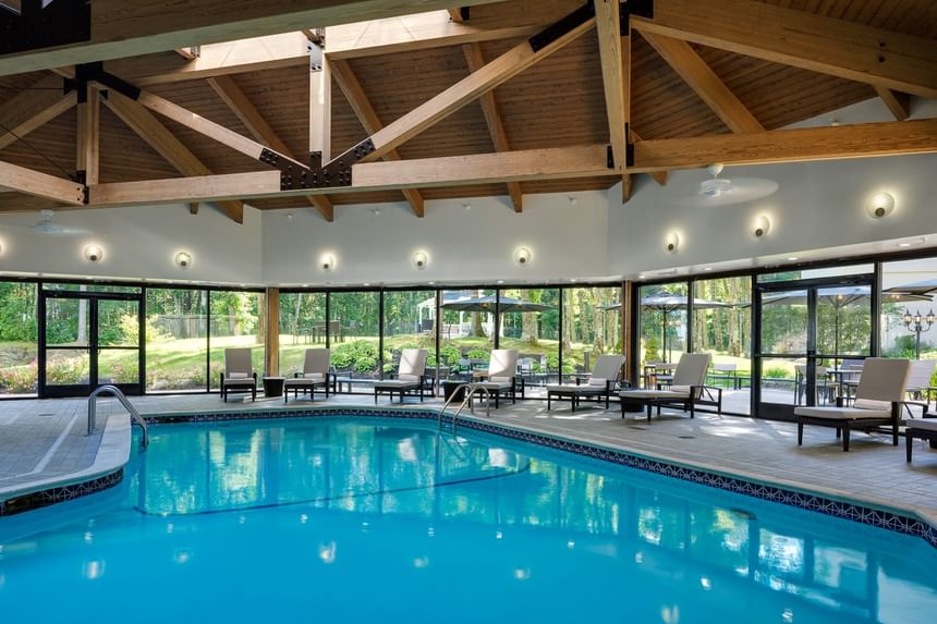 Indoor heated swimming pool with lounge chairs at Sable Oaks Weddings and Events among hotels in Portland Maine USA