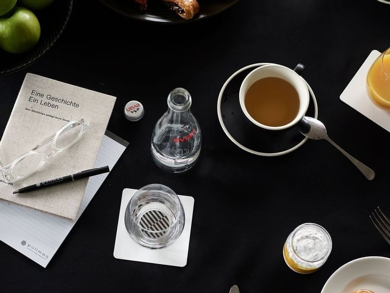 tea, papers & pen on the table at Pullman Melbourne on the park