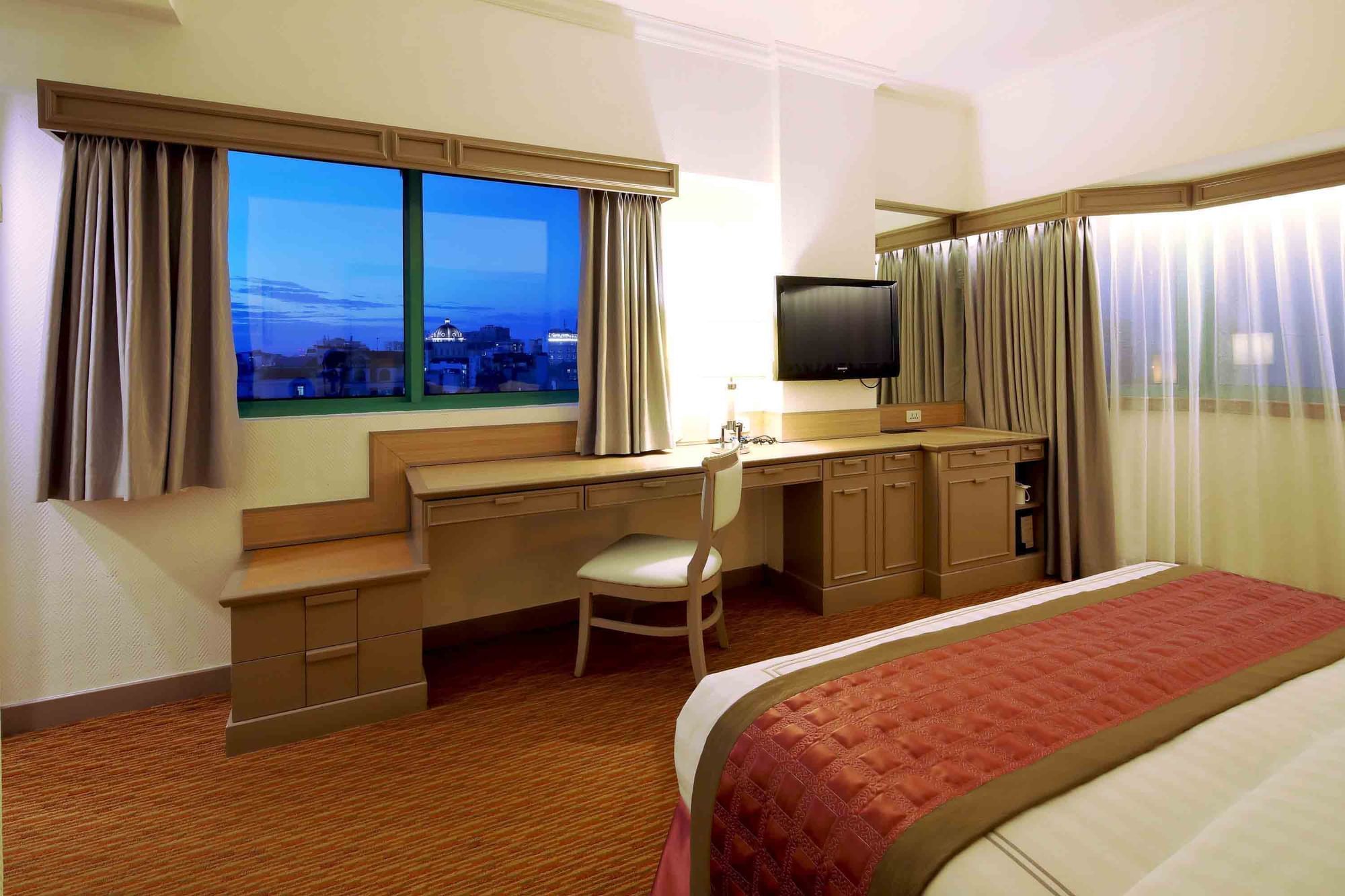 Cozy bed with TV & work area in Club City View King at Sunway Hotel Hanoi
