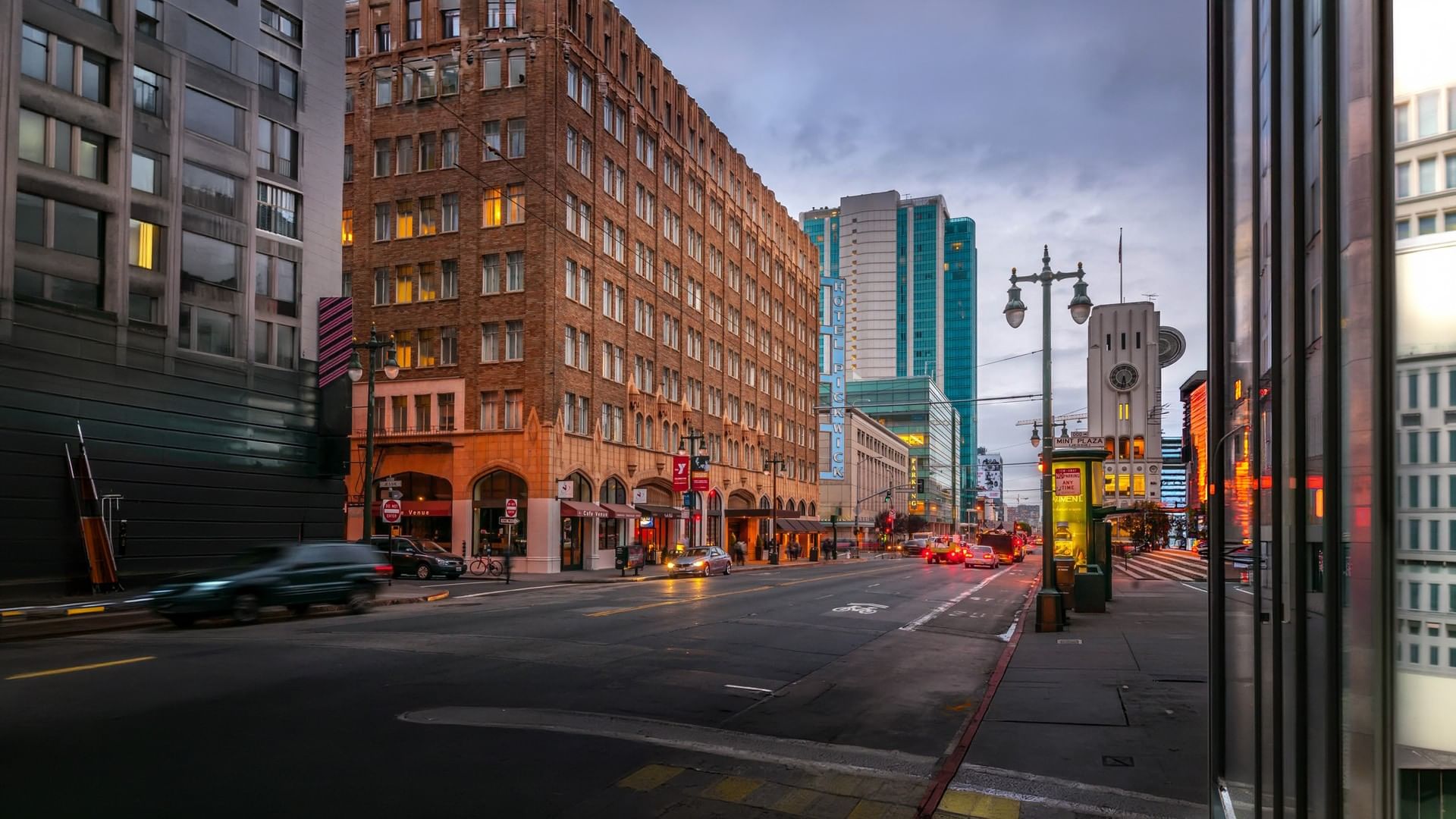 City street with buildings and vehicles at dusk, view from Pickwick San Francisco.