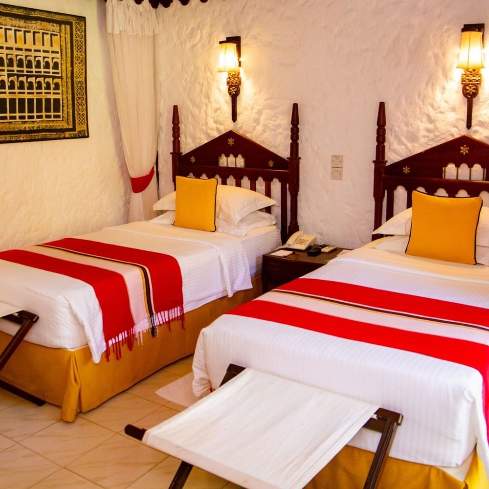 Two beds with garden view in Deluxe Twin room at Serena Beach Resort & Spa Mombasa.