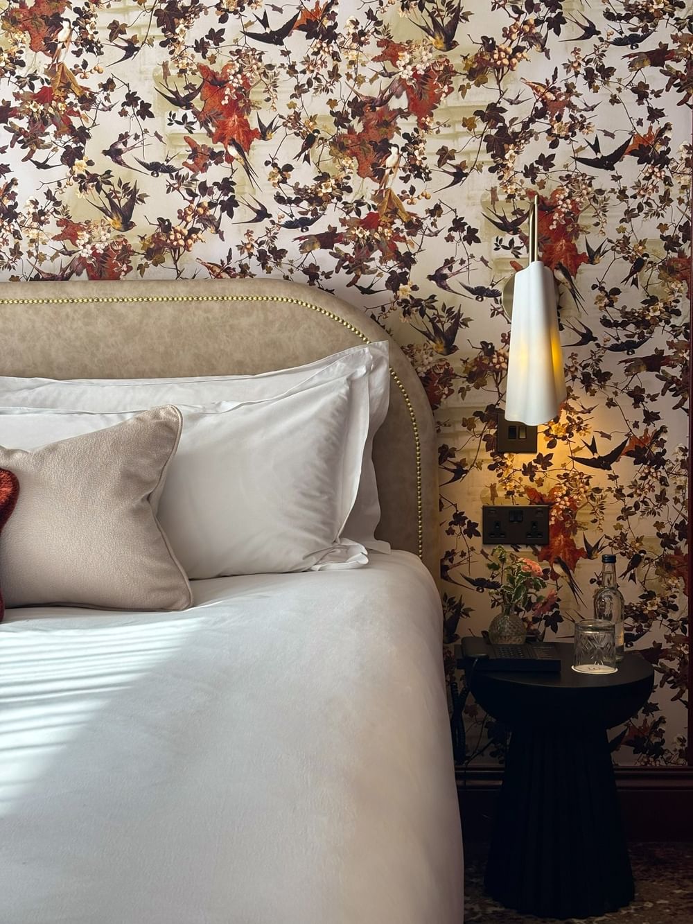 Superior Room with floral wallpaper, comfortable bed, and modern lighting at The Capital Hotel London