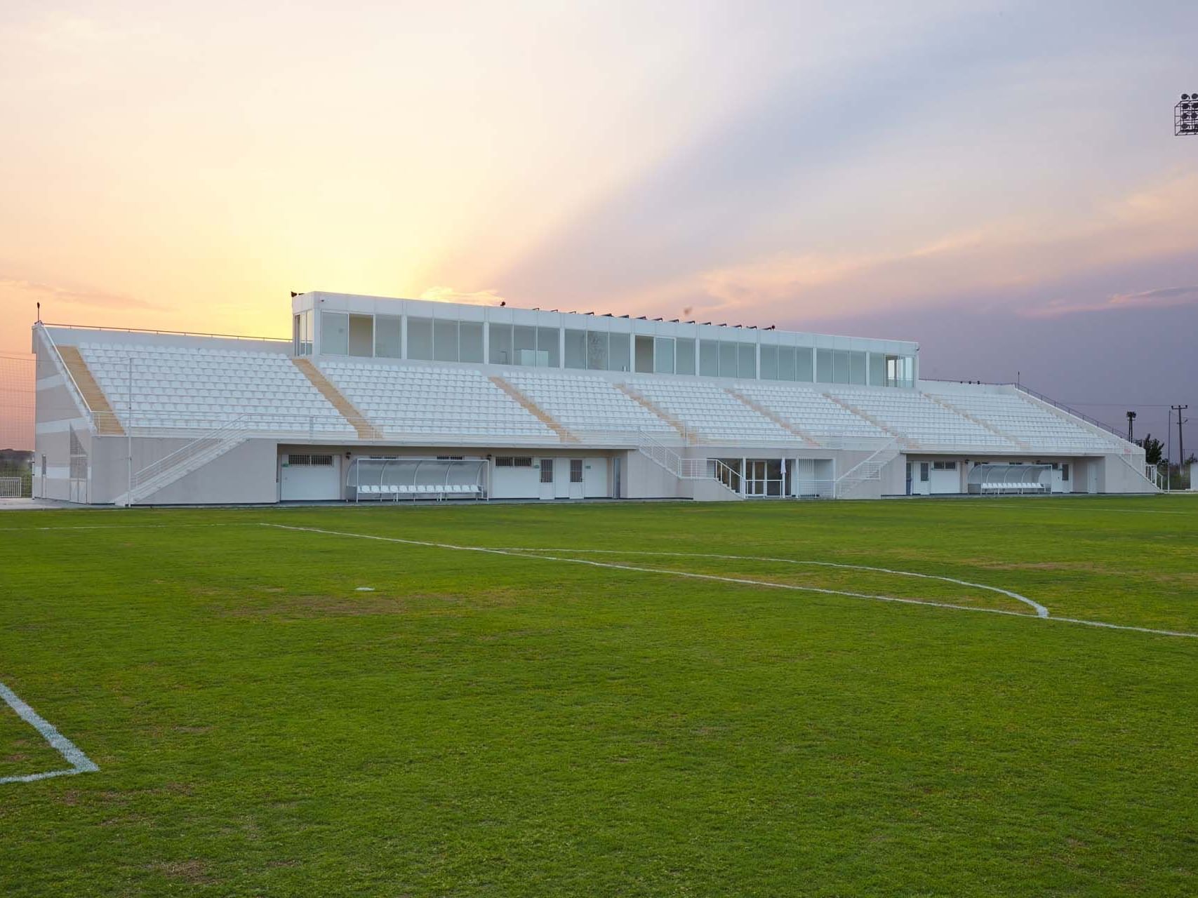 Modern stadium with soccer field at sunset near Titanic Deluxe Golf Belek