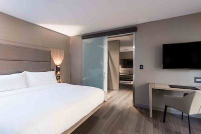 cozy bed in modern hotel room with tv