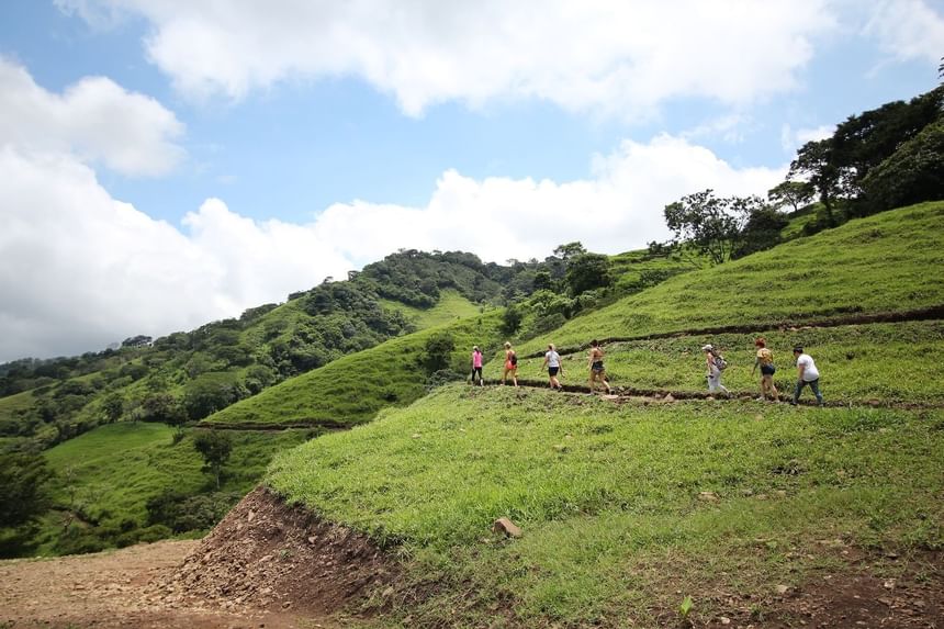 People climbing mountain with bags near Retreat Costa Rica