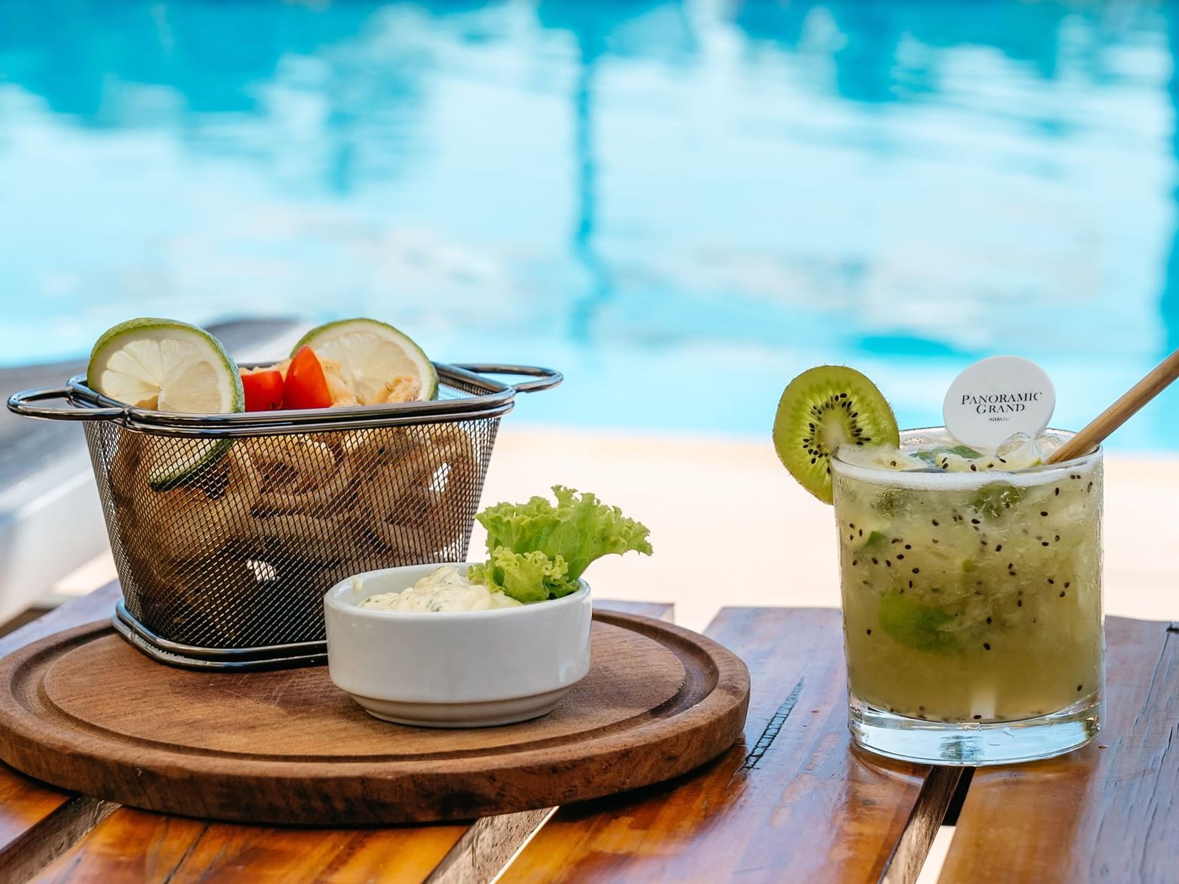 Close-up of cocktail served with some snacks at Panoramic Grand