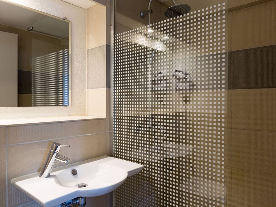 Bathroom vanity in bedrooms at Hotel Porte de Geneve