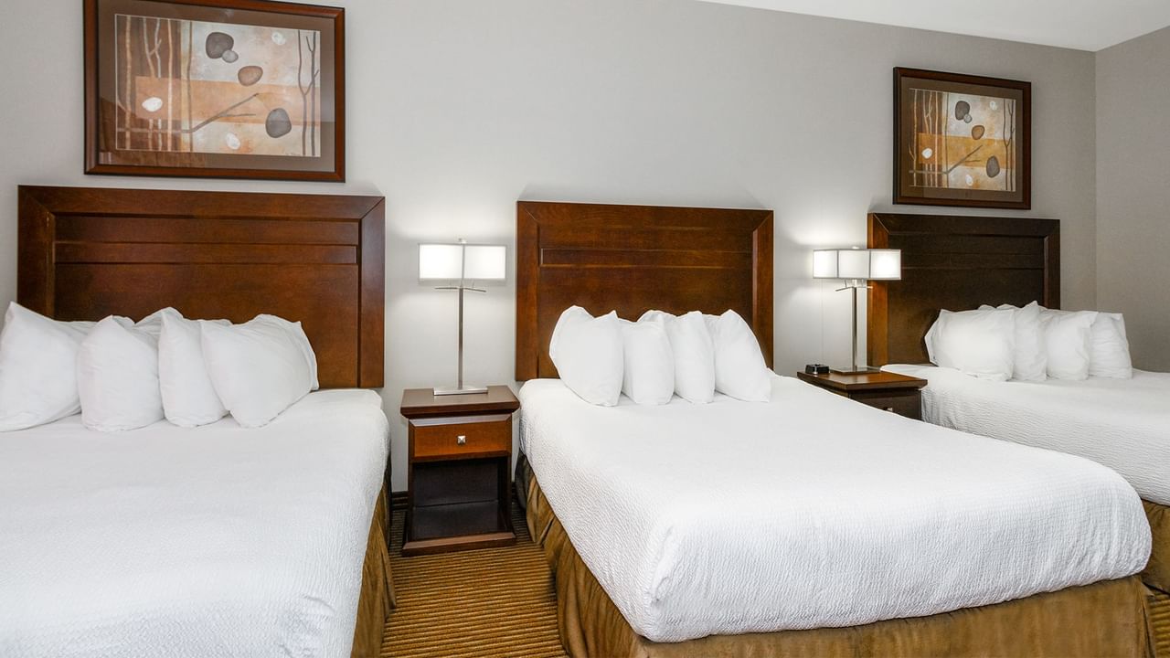 Hotel room with three queen beds