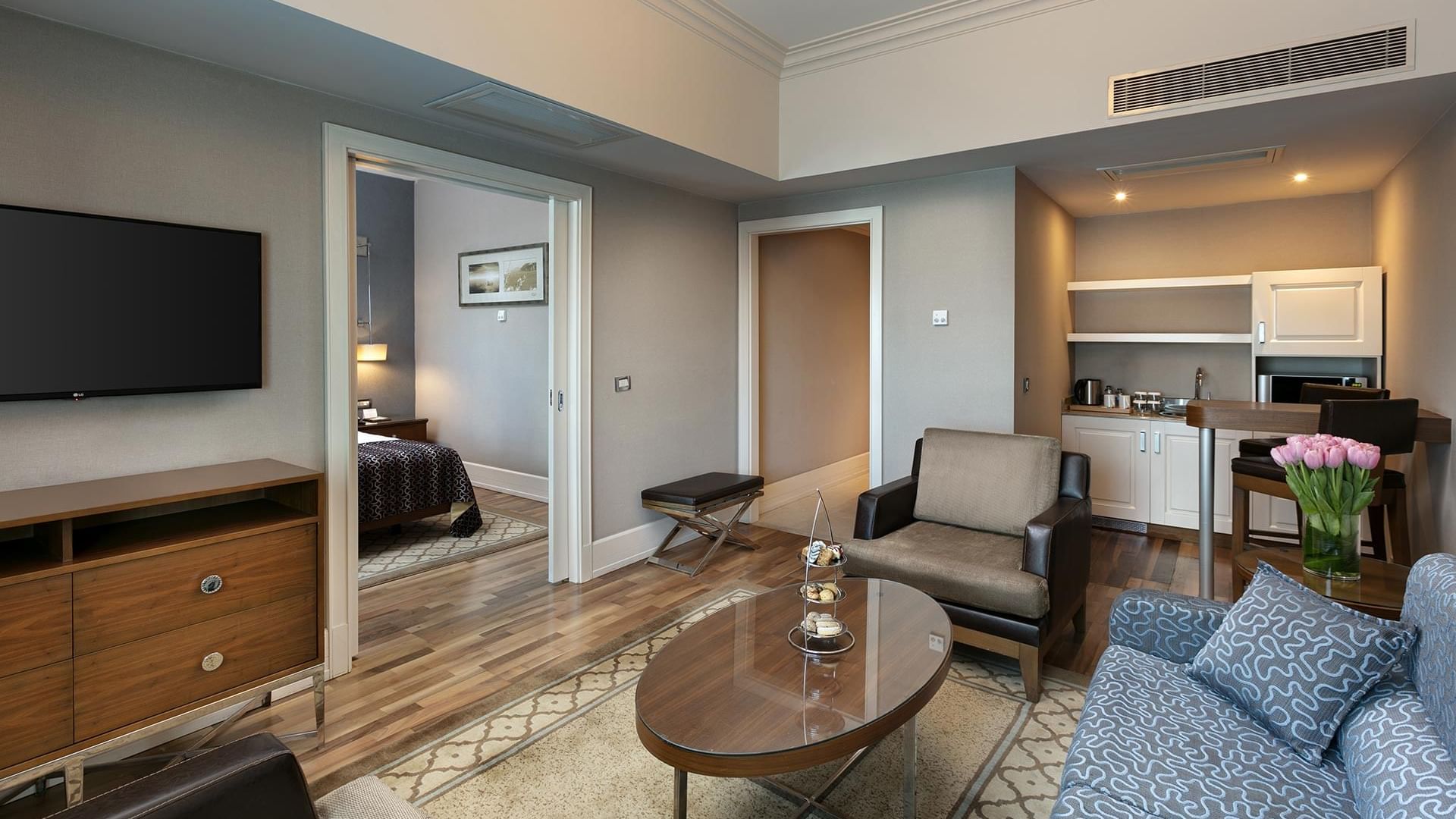 Wooden finished spacious living room with cozy loungers in Club Suite at Titanic Business Kartal