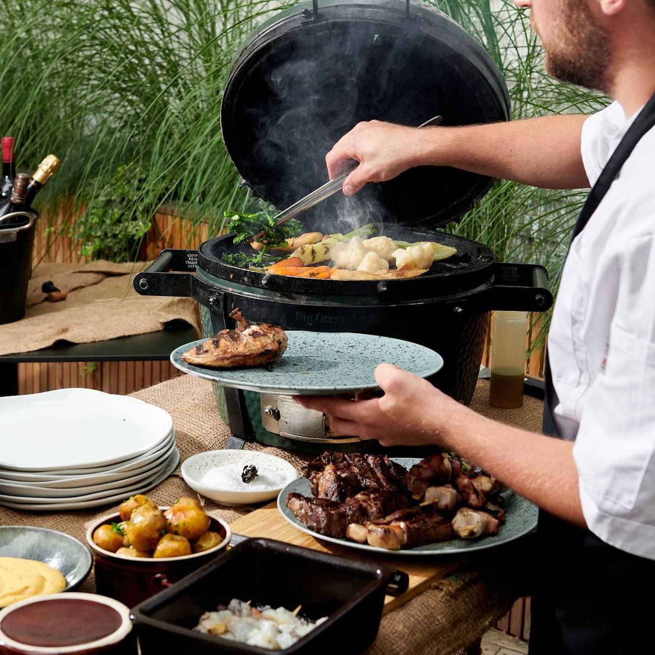 Chef preparing meals outdoors at Almanac X Alcron Prague, Fancy Restaurants Prague