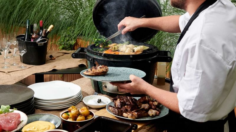 Chef preparing meals outdoors at Almanac X Alcron Prague, Fancy Restaurants Prague