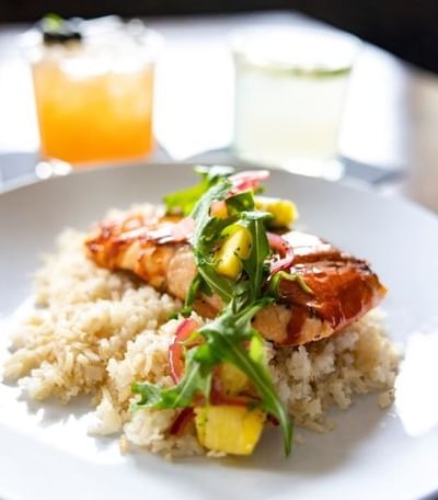 Jose Restaurant grilled fish atop rice with pineapple salsa and greens at Elevation Resort Spa