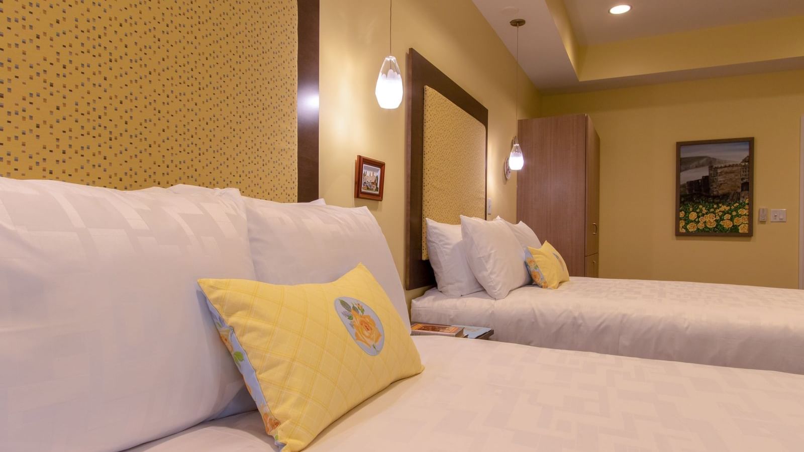 Pillows on beds in England-themed Room at The Whittaker Inn