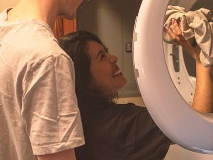 Close-up of a couple doing laundry together at Blackstone Mountain Lodge