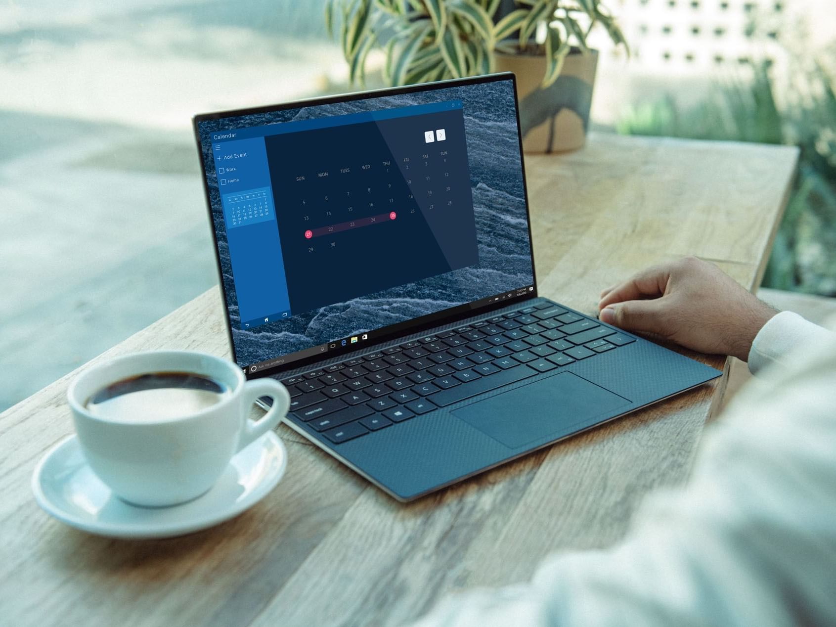 A man using a laptop and coffee cup outdoor at Pelham on Earle