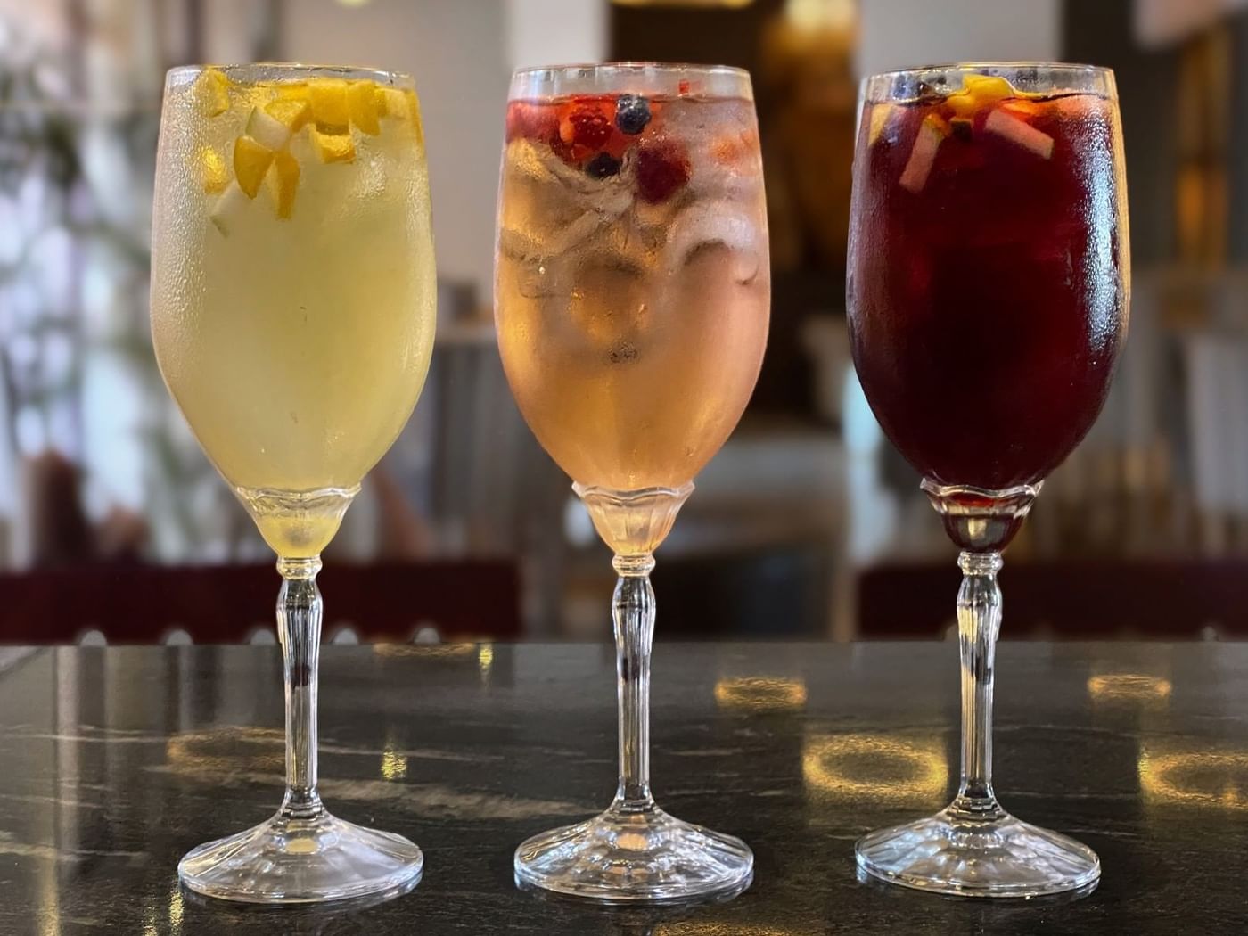 Close-up of three colorful cocktails served in Stelaris Cocktail Lounge at Grand Fiesta Americana