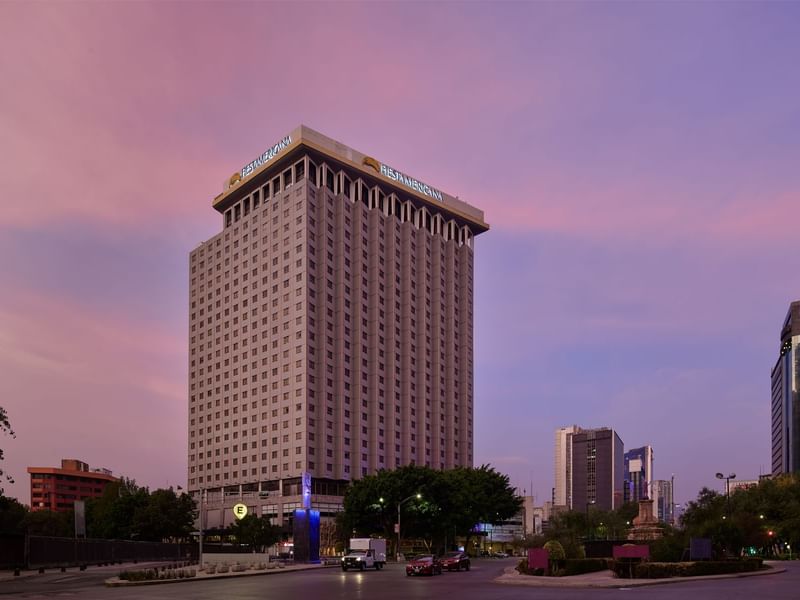 Grand Fiesta Americana hotel building against a beautiful pink and purple sky at dusk, a city landmark