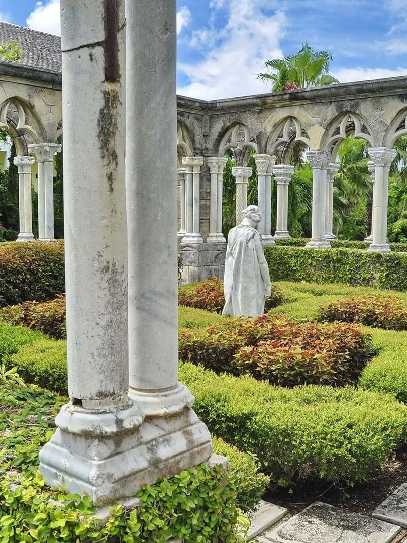 The Cloisters Bahamas Gardens by manicured hedges under gothic arches near Warwick Paradise Island Bahamas