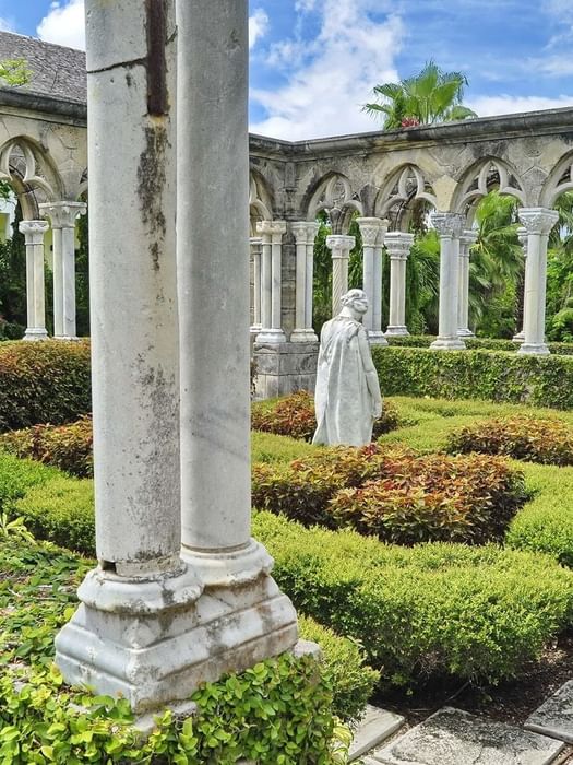 The Cloisters Bahamas Gardens by manicured hedges under gothic arches near Warwick Paradise Island Bahamas