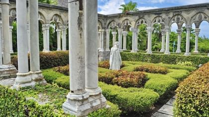 The Cloisters Bahamas Gardens by manicured hedges under gothic arches near Warwick Paradise Island Bahamas