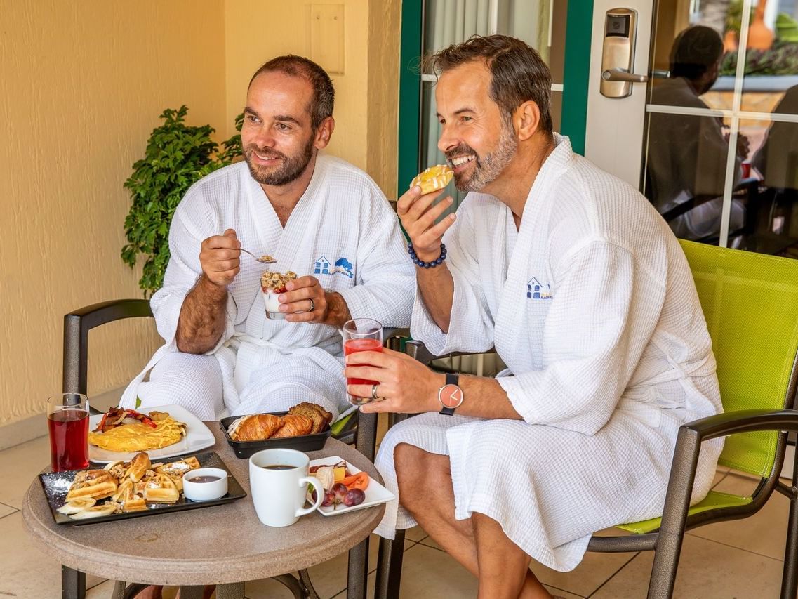 Two men having breakfast in bathrobe at Amsterdam Manor Resort