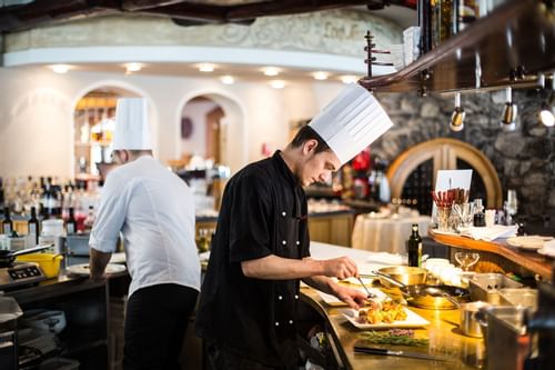 Chefs at Grotto Valle restaurant's kitchen in Liebes Rot Flueh