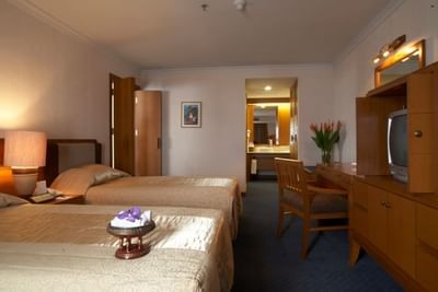 Cozy beds with TV & working area at Amora Hotel Chiang Mai