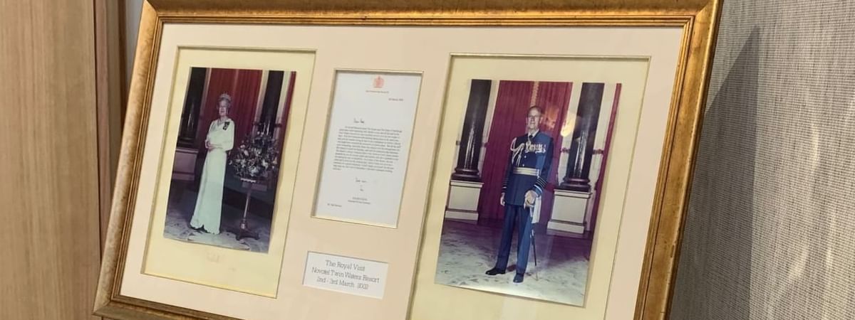 Framed display with photos and a letter from Queen Elizabeth II's 2002 visit to Novotel Sunshine Coast Resort