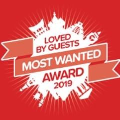 Logo of Loved by Guests Most Wanted Award at One Farrer Hotel