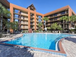 Outdoor pool area & hotel at Rosen Inn Lake Buena Vista