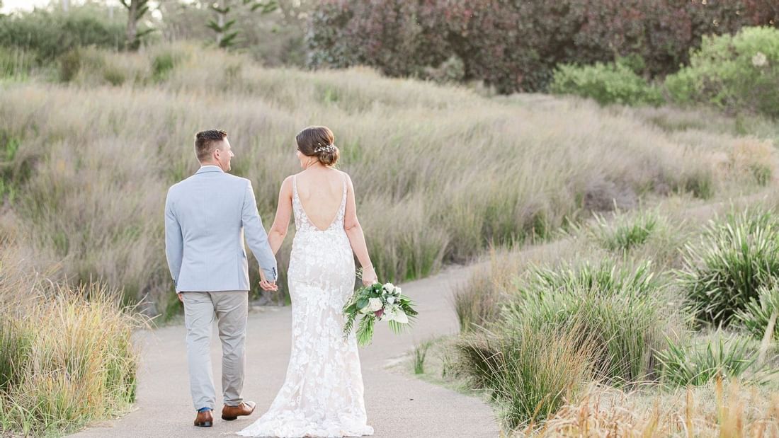 Wedding couple walking together at Pullman Magenta Shores