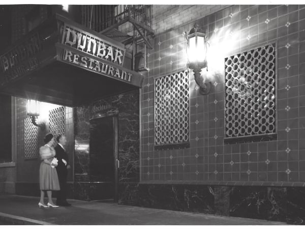 Vintage image of a couple entering Dunbar restaurant at Hotel Sorrento