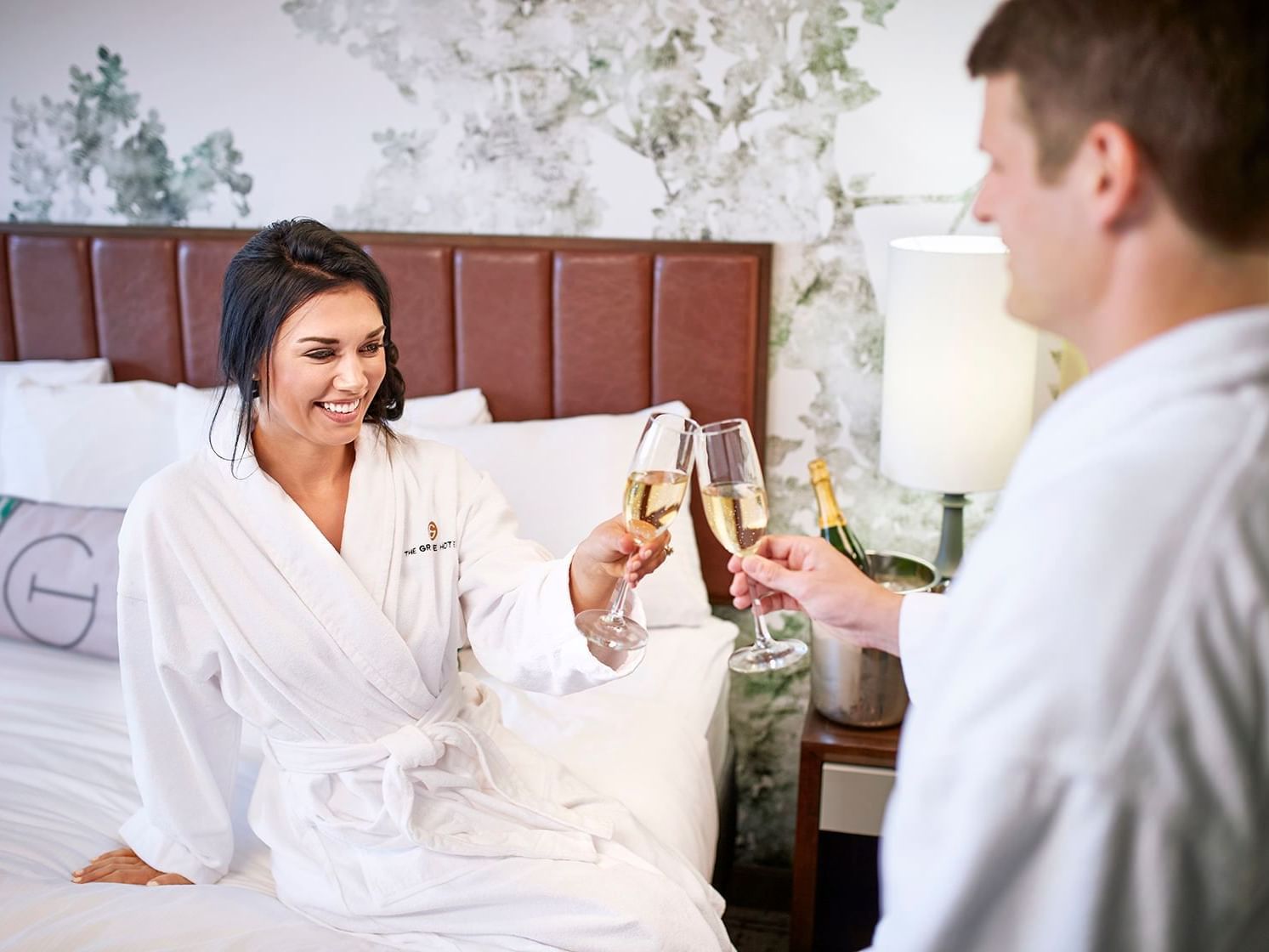Couple toasting with champagne in a room at The Grove hotel