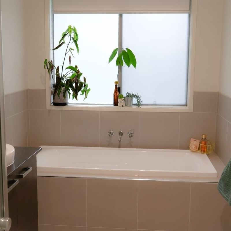 A clean bathroom with a bathtub and sink at La Trobe University Regional Housing - Ballarat.