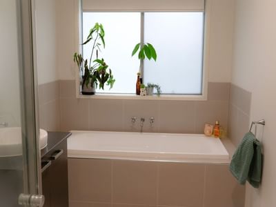A clean bathroom with a bathtub and sink at La Trobe University Regional Housing - Ballarat.