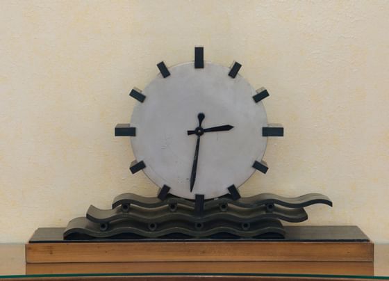 Close-up of a wooden stand clock displaying the time at Bettoja Hotels Group