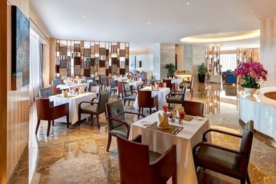 Dining table arrangement with modern interior & decor at One World Hotel