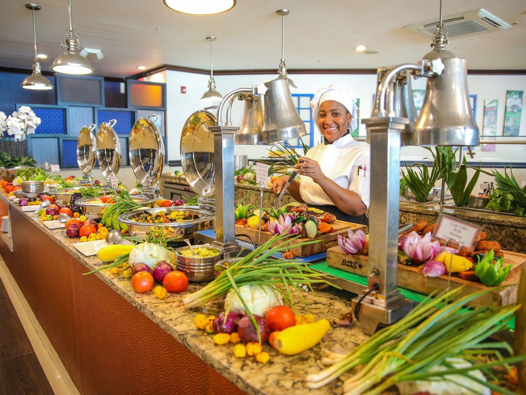 A chef by the food bar in Blue Window Restaurant at Jamaica Pegasus Hotel