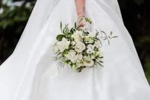 A bride in a flowing white gown holds a beautiful bouquet of white flowers in a wedding at The Aberdeen Altens Hotel